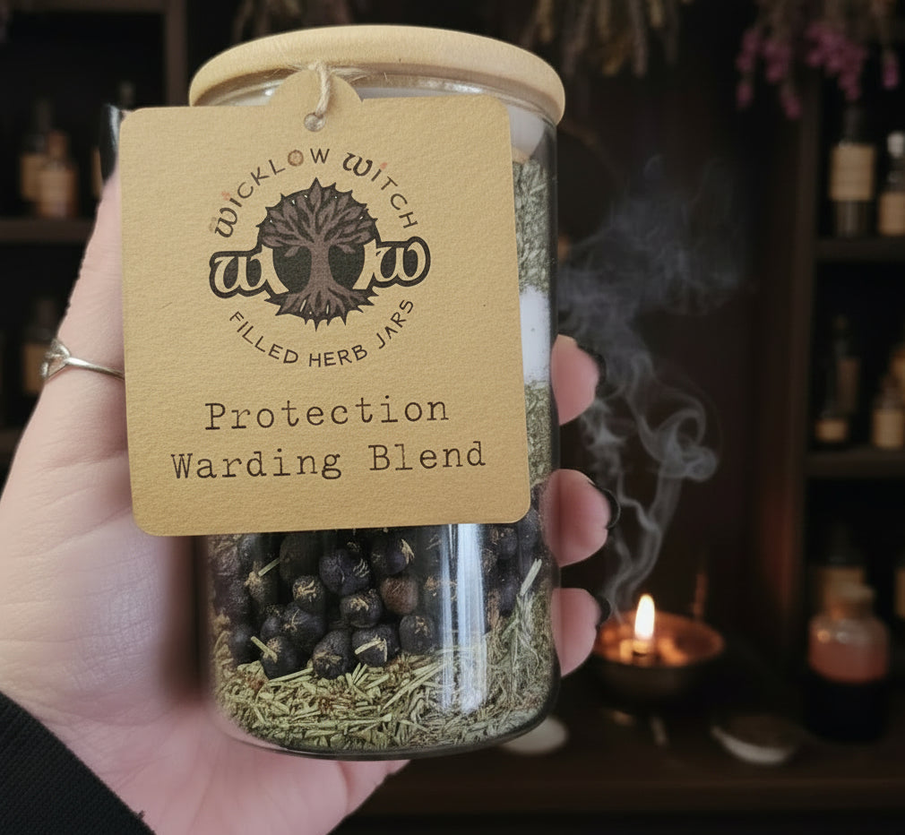 Jar of 'Protection Warding Blend' with a 'Wicklow Witch' label held by a hand.
