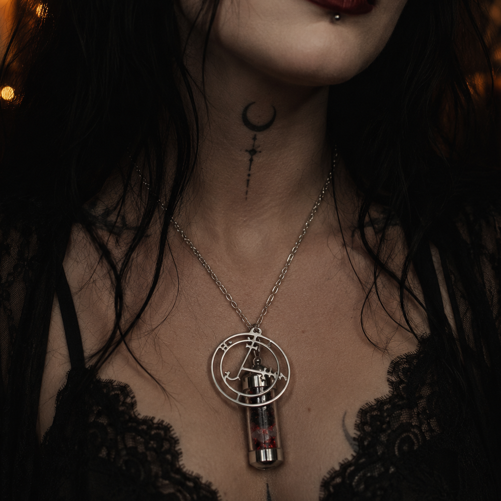 Close-up of a person wearing a necklace with a key pendant in a dimly lit setting