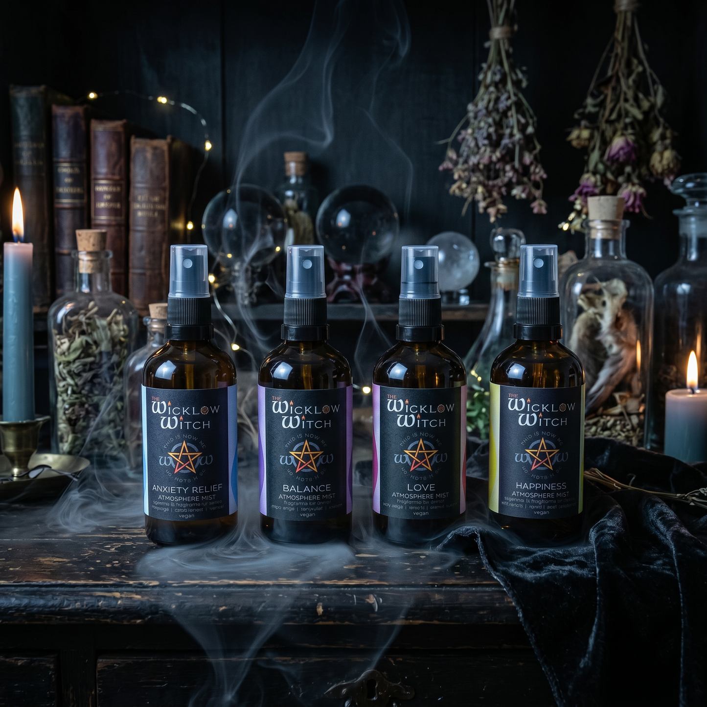 Four bottles of Wicklow Witch elixirs on a dark wooden table with candles and books in the background.