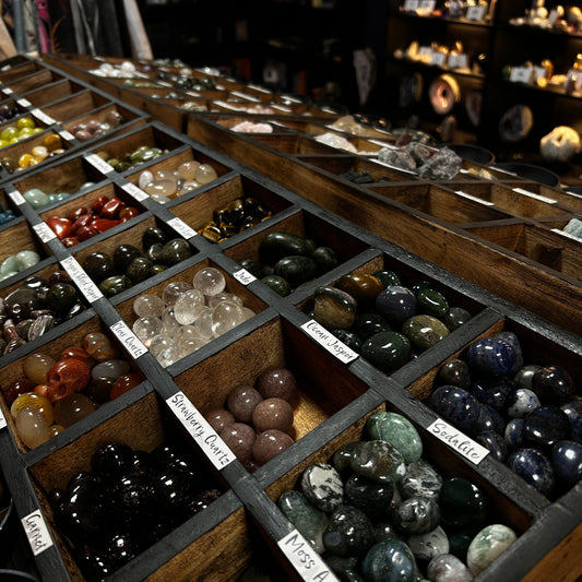 filled boxes of crystal tumbles